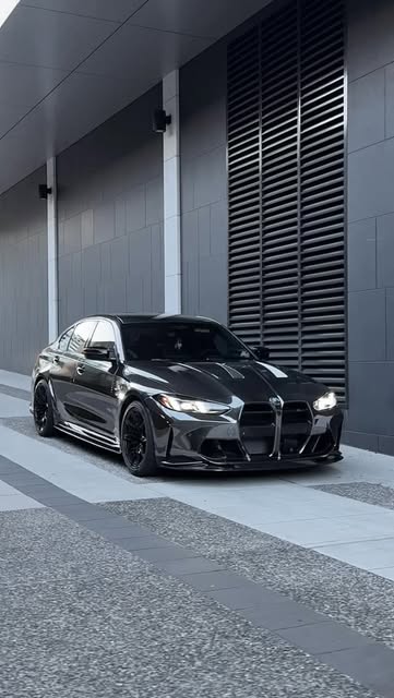 Modified black BMW M3 photographed outdoors